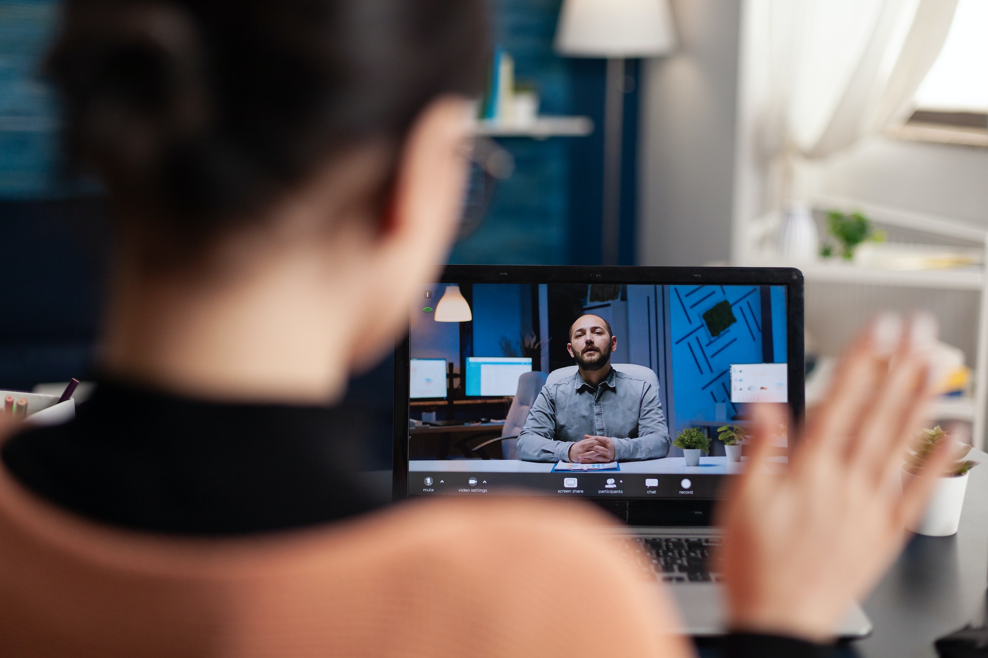 Student greeting her university teacher during virtual meeting